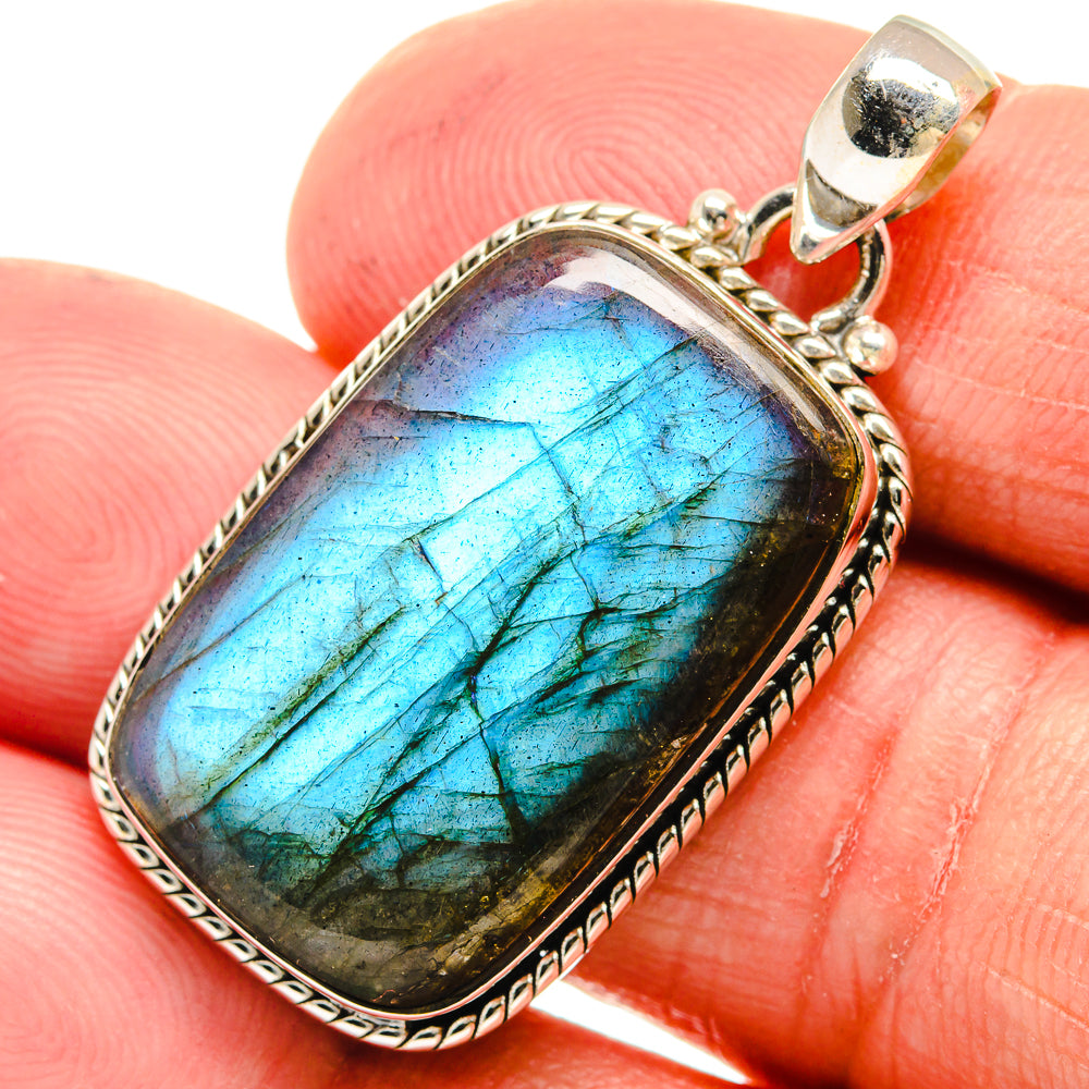 Sterling silver labradorite pendant with oval blue-green gemstone and textured bezel