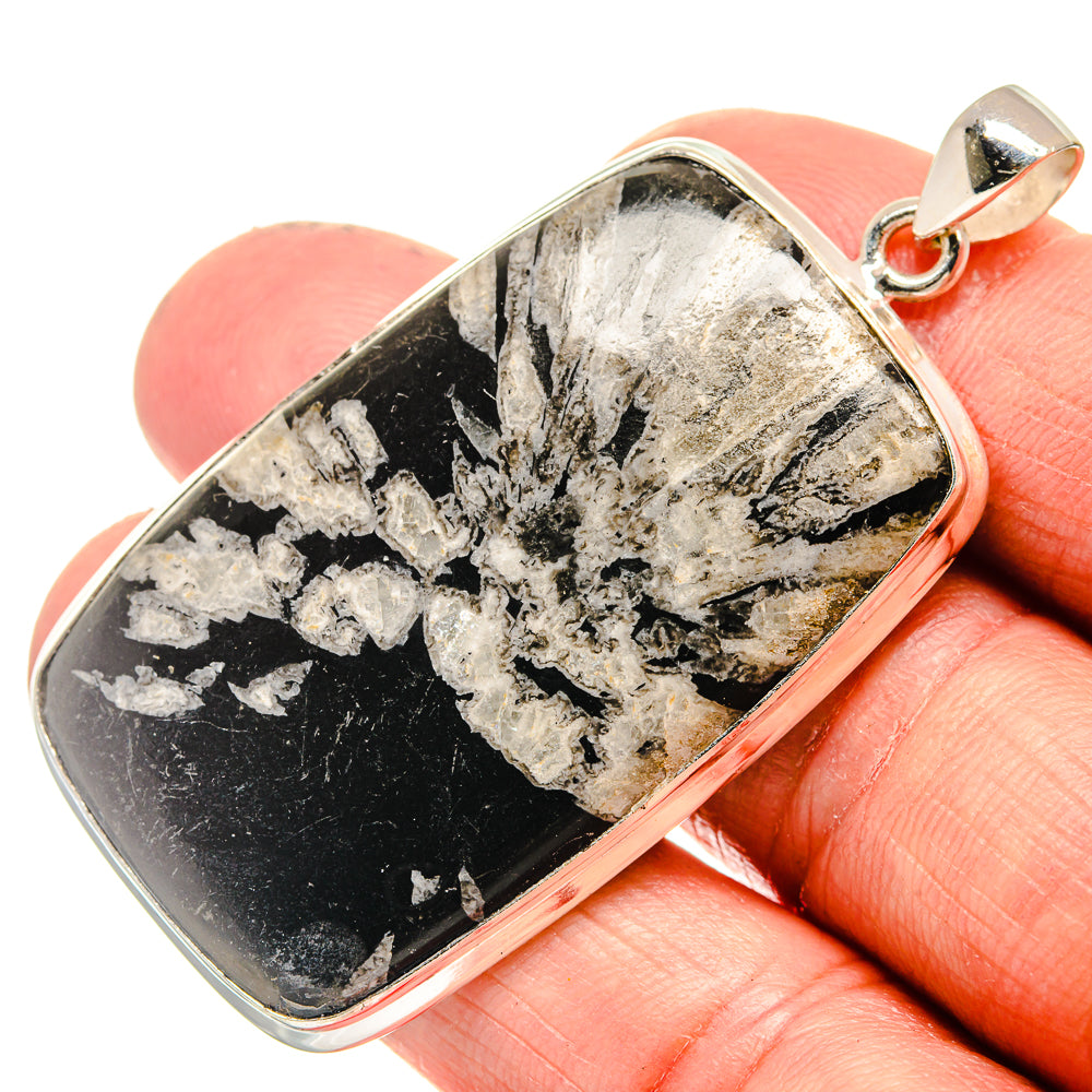 Sterling silver rectangular chrysanthemum stone pendant with loop bail, shown in hand