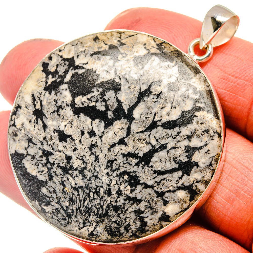 Round chrysanthemum stone pendant in gold-tone 925 sterling silver bezel, close-up.