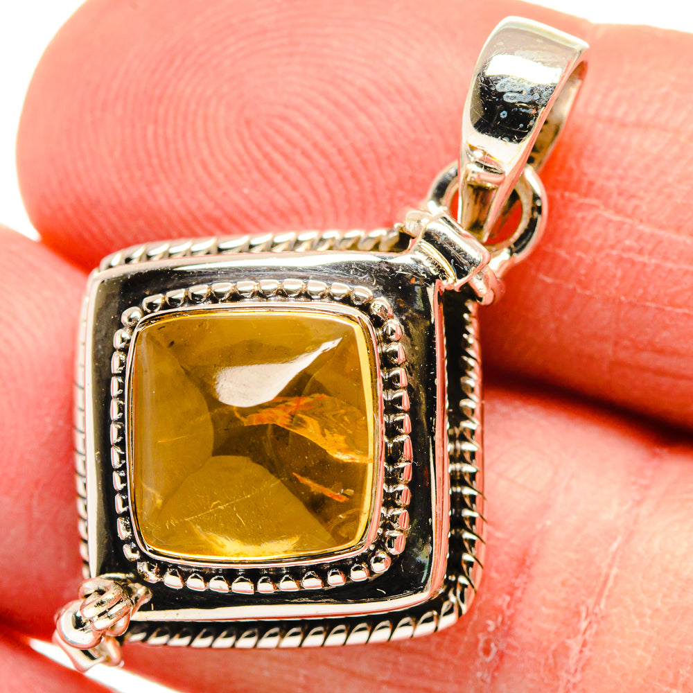Close-up square citrine pendant with silver frame, bead trim, and polished bail ring