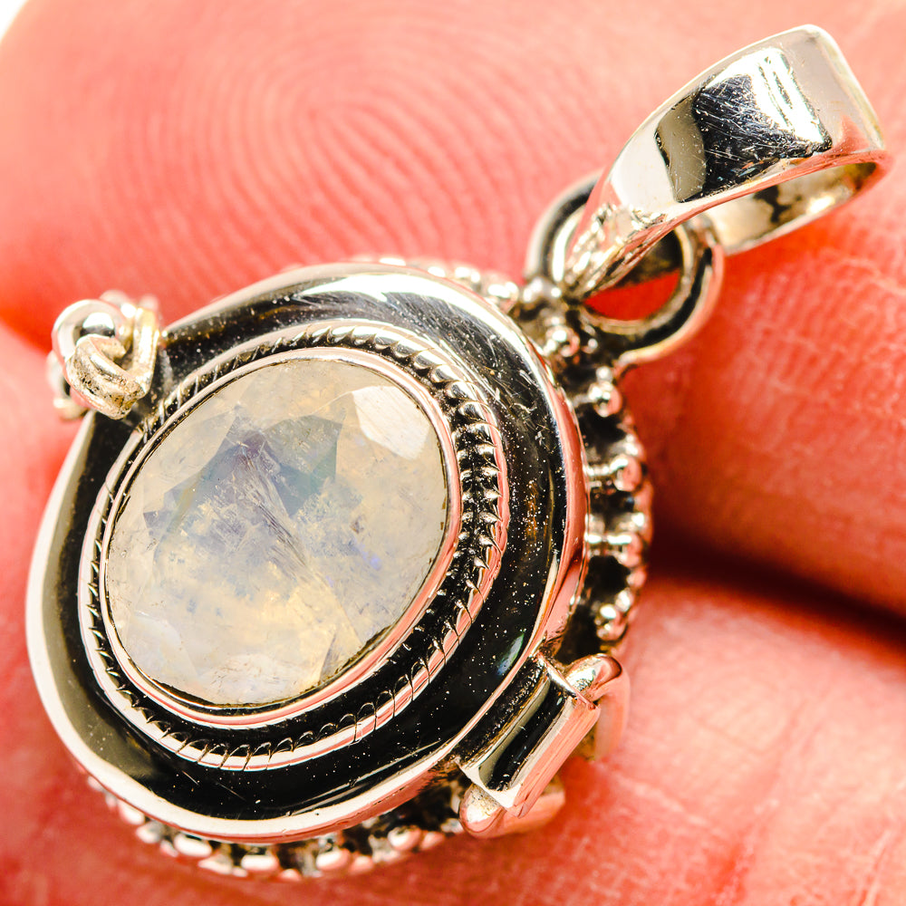 Sterling silver oval moonstone pendant with rope-edge bezel and black accents