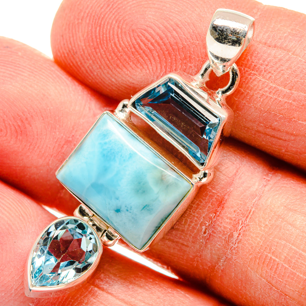 Sterling silver pendant close-up with rectangular larimar-style stone and teardrop blue topaz