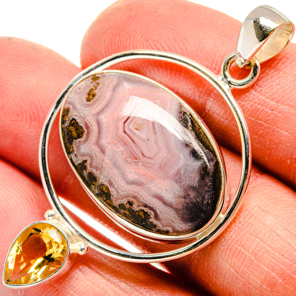 Oval Ocean Jasper pendant in silver with citrine drop detail, close-up on gemstone.