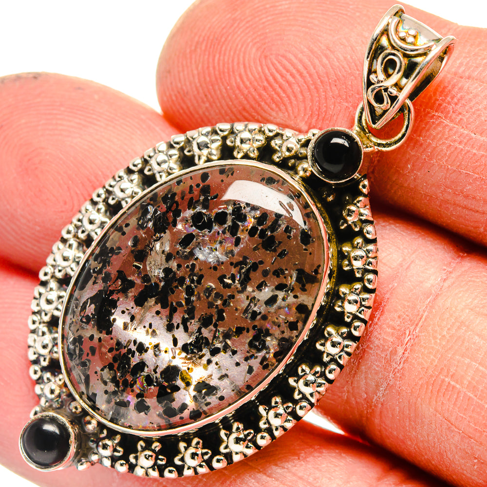 Black onyx and dendritic opal pendant with ornate silver bezel, oval stone with black accents