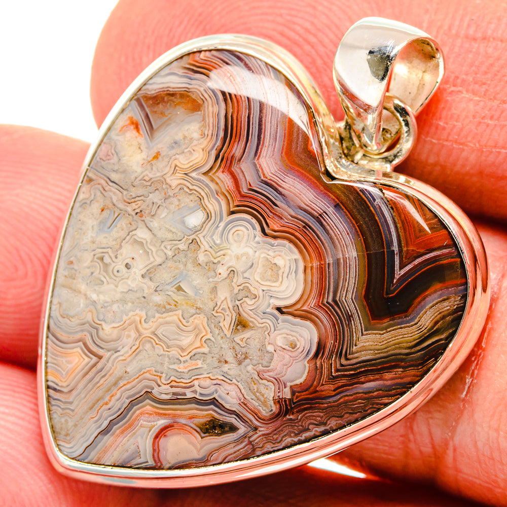 Sterling silver agate heart pendant, close-up of banded brown and orange stone
