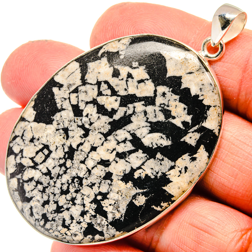 925 sterling silver teardrop pendant showing black-and-white stone face with bail