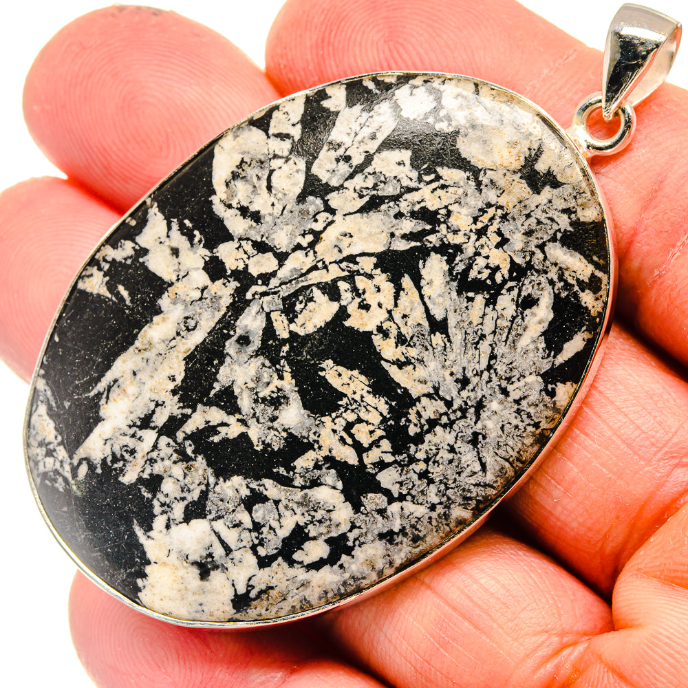 Black-and-white speckled stone pendant with sterling silver bezel and bail
