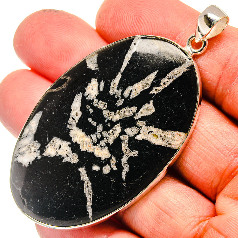 Sterling silver pendant with black teardrop stone and white chrysanthemum pattern
