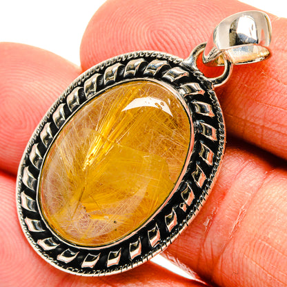 Oval rutilated quartz pendant, yellow cabochon in ornate sterling silver bezel with bail.