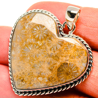 Orange amber coral heart pendant with sterling silver twisted rope border and bail