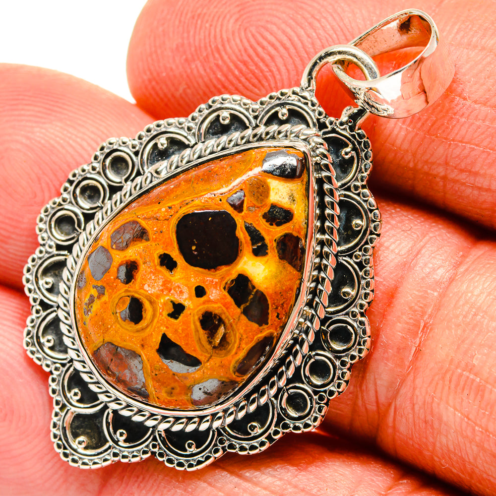 Sterling silver teardrop pendant with orange bauxite stone and black speckled inlay