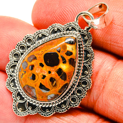 Sterling silver teardrop pendant with orange bauxite stone and black speckled inlay
