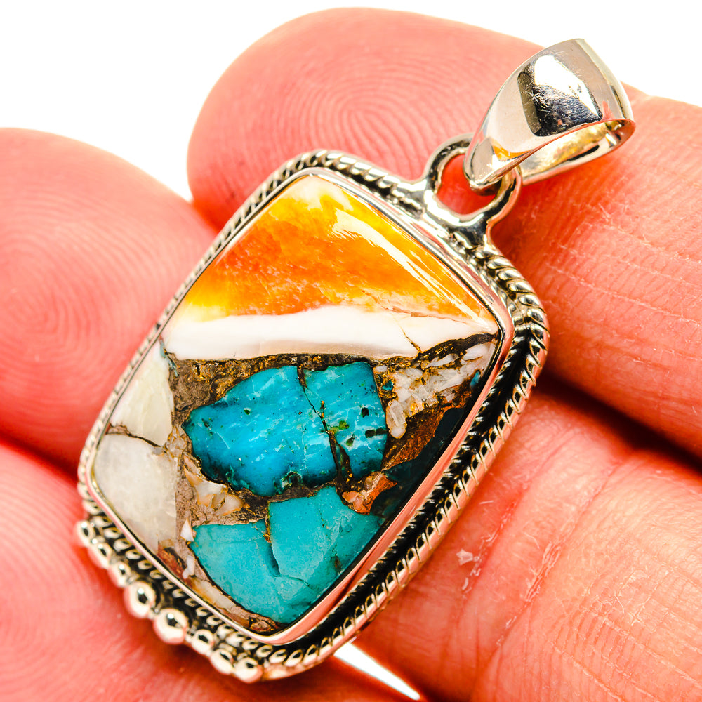 Turquoise oyster shell pendant in silver-tone bezel with bail, teardrop shape