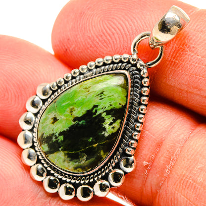 Green teardrop opal pendant close-up on bail and textured silver bezel