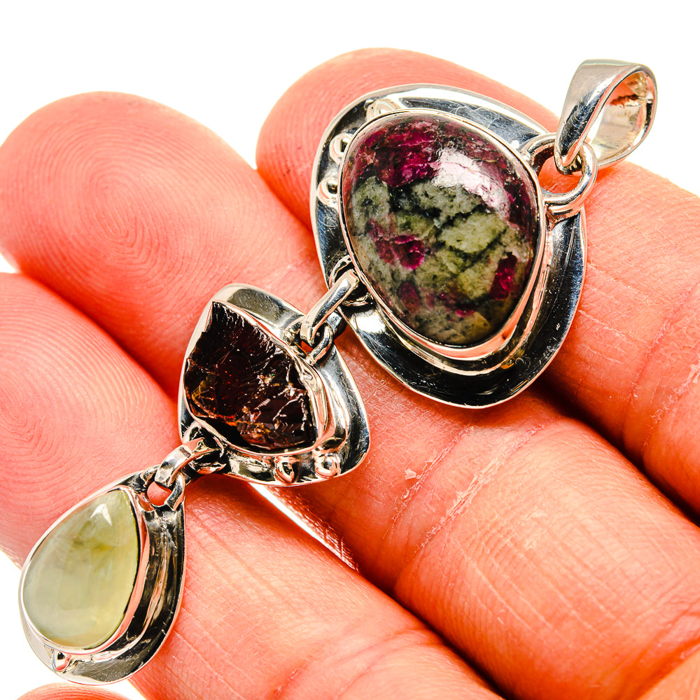 Sterling silver pendant close-up with marbled oval, orange drop, and pale yellow teardrop