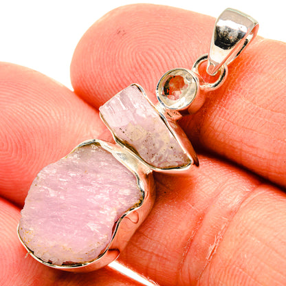 Closeup rough pink pendant with 925 sterling silver bezel and small round orange stone accent