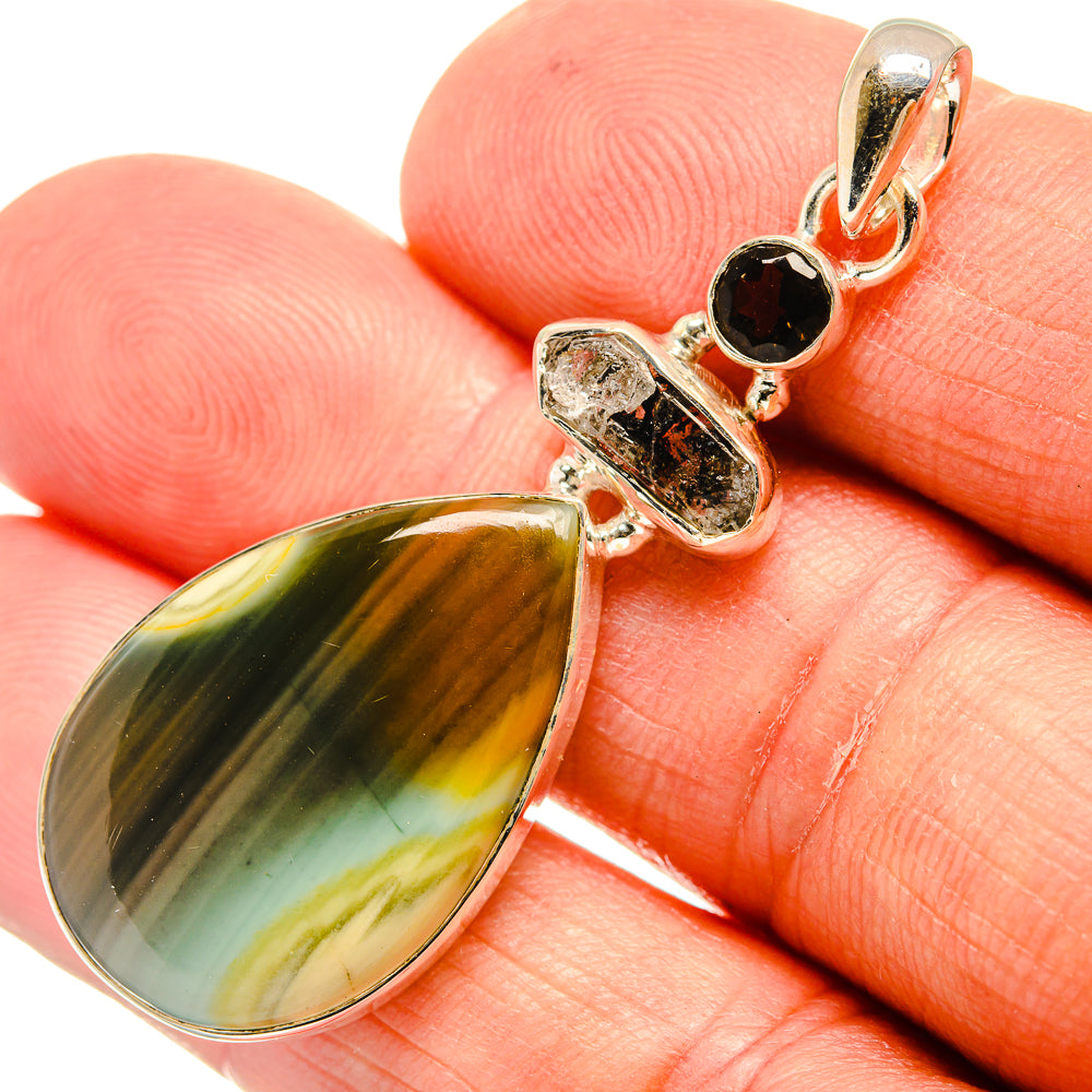 Sterling silver pendant with green-yellow teardrop stone and small black round accents