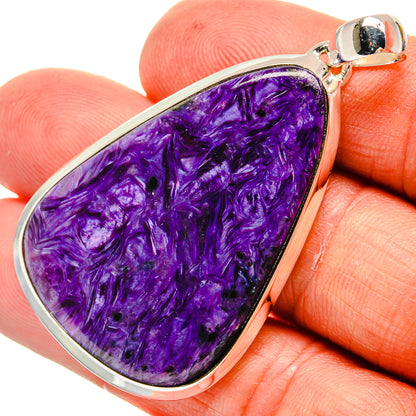 Purple charoite teardrop pendant in 925 sterling silver bezel, close-up bail