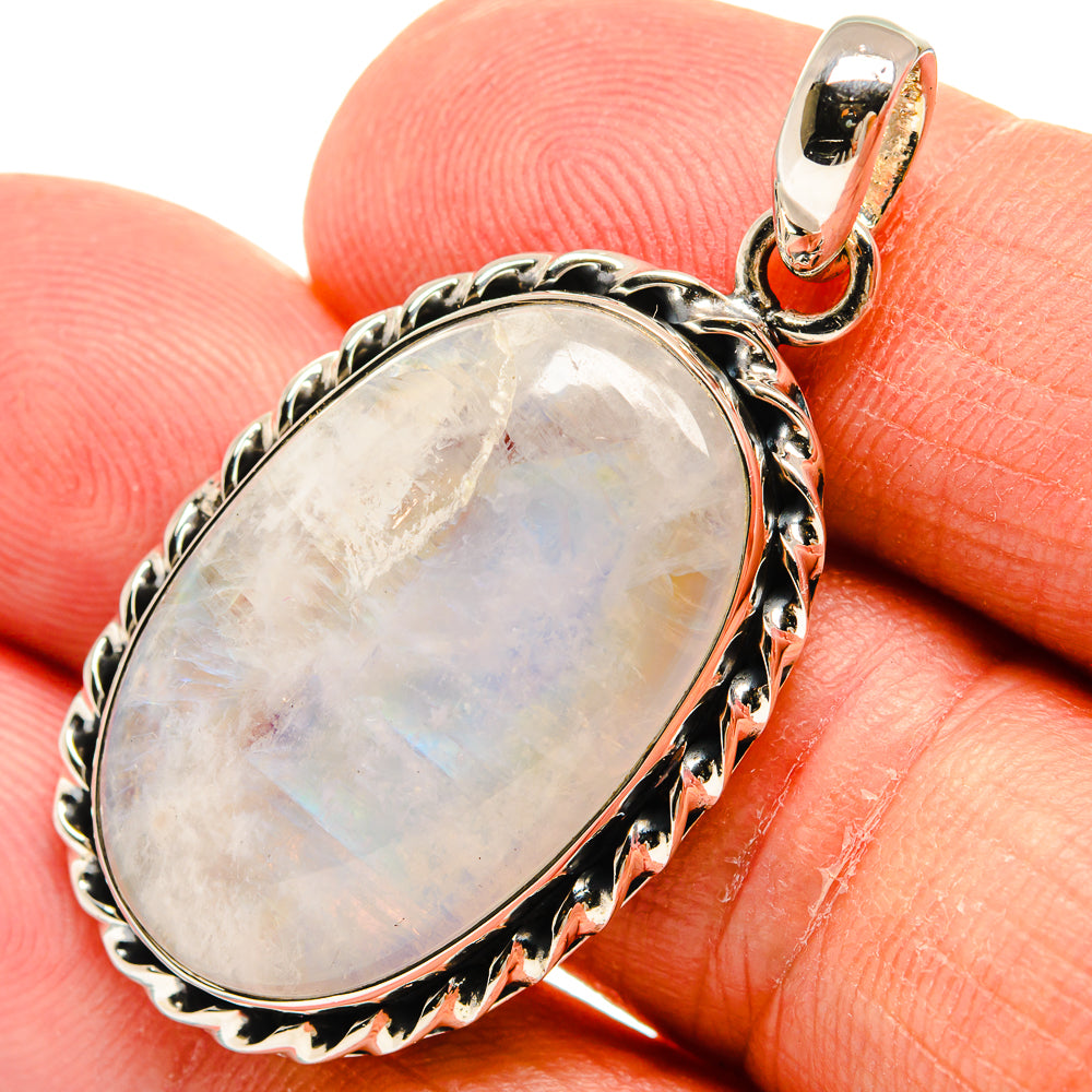 Oval moonstone pendant with iridescent white opalescence and sterling silver bezel
