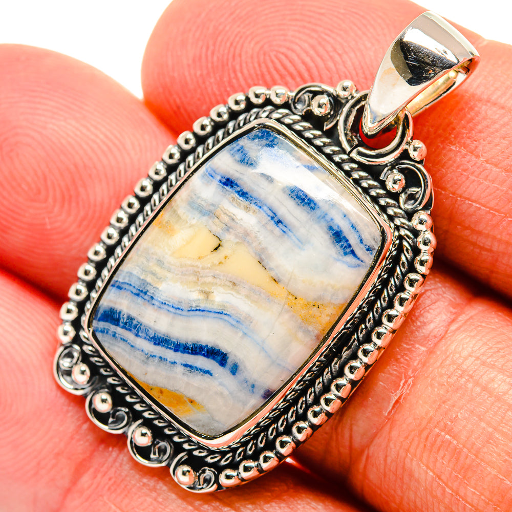 Rectangular blue scheelite pendant in silver bezel with ornate round bead frame and bail