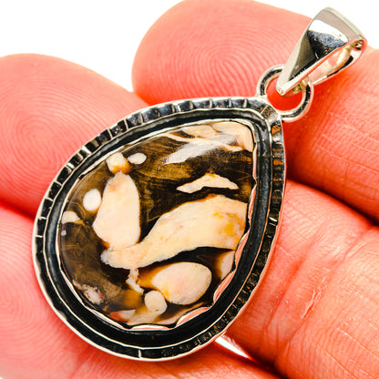 Brown-and-cream jasper oval pendant in 925 sterling silver bezel, shown on finger