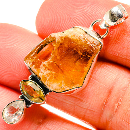 Rough orange-gold quartz pendant with sterling silver bezel and attached drop charms