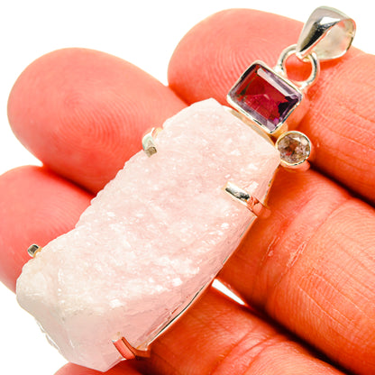 Rough light pink quartz pendant with silver bail and dark red and purple side stones