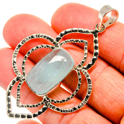 Oval aquamarine pendant in ornate 925 sterling silver setting with bail loop.