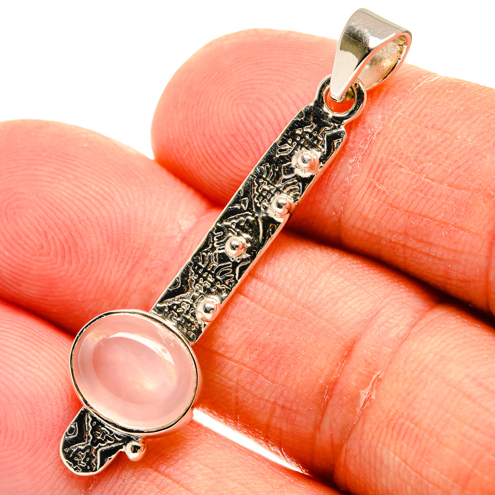 Round pink rose quartz pendant close-up on 925 sterling silver ornate frame