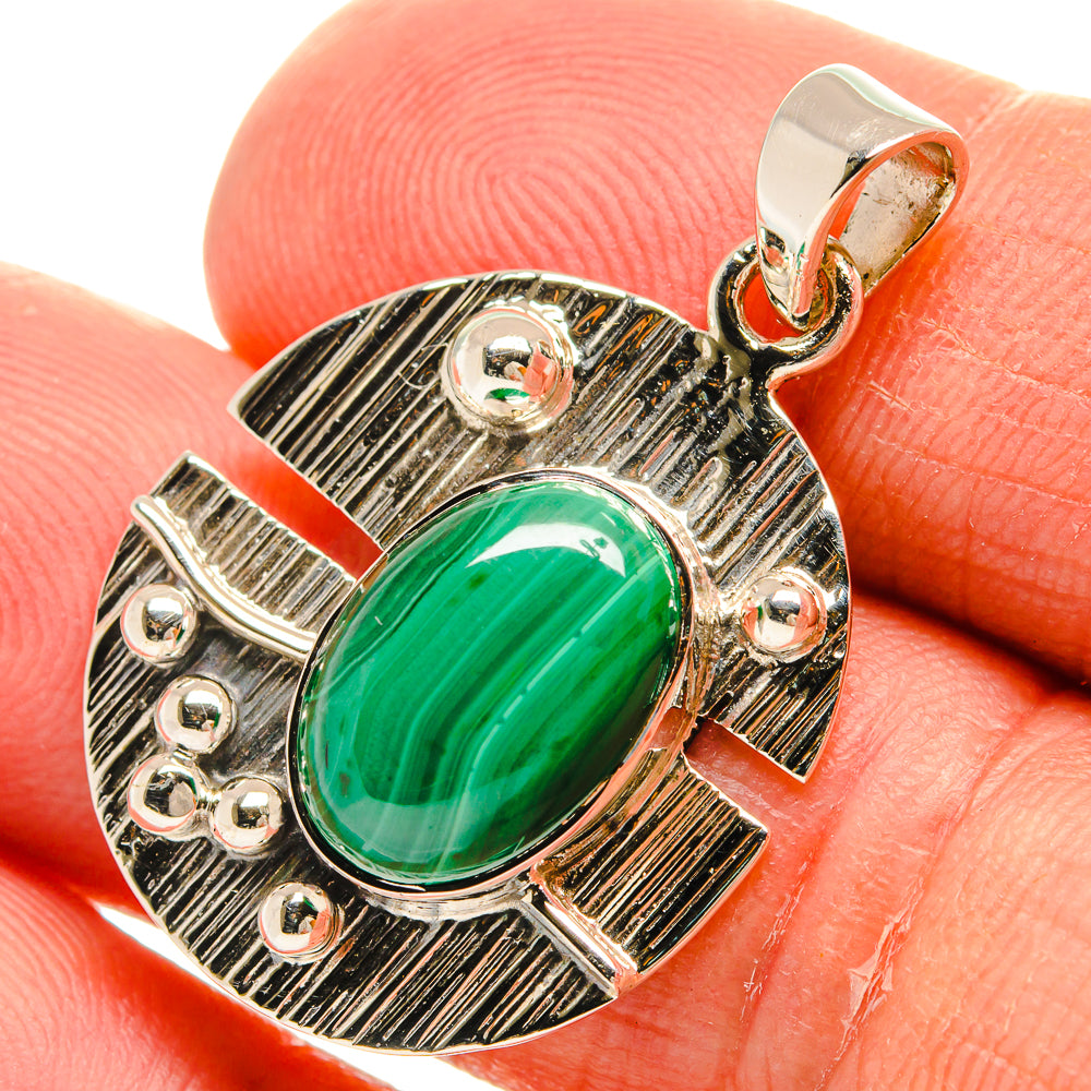 Oval green malachite pendant in textured 925 sterling silver with round bail loop