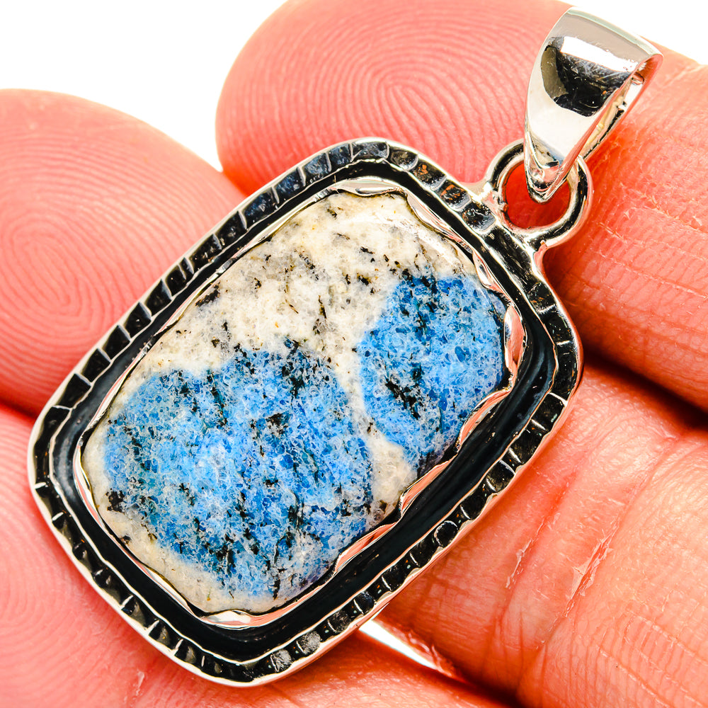 Close-up sterling silver pendant with blue azurite stone in detailed oval frame