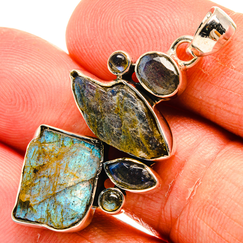 Rough labradorite pendant with blue and yellow stone pieces in silver setting