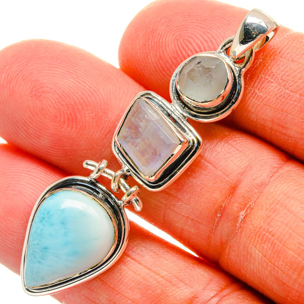 Three-stone 925 sterling silver pendant with blue oval and iridescent rectangular stones.