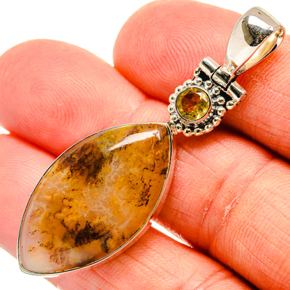Teardrop amber agate and round citrine pendant on 925 silver bail, close-up