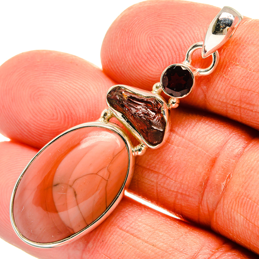 Sterling silver gemstone pendant, close-up of orange jasper oval and dark red stones