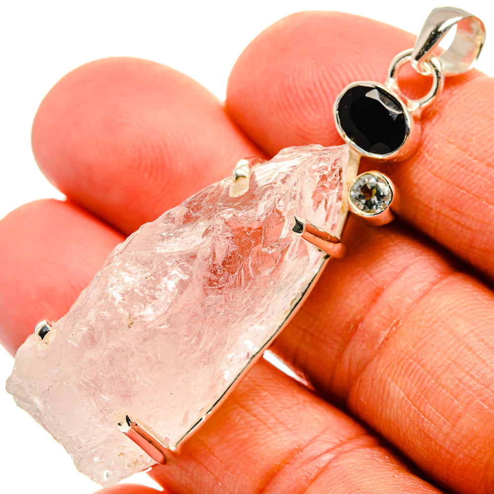 Rough moonstone pendant detail with black onyx drop and round blue stone in silver