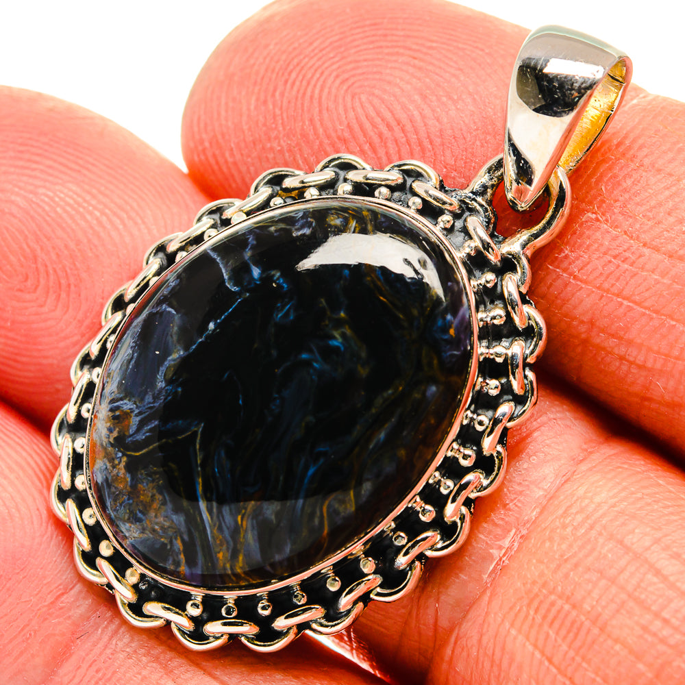 Sterling silver pietersite pendant with oval blue cabochon, ornate bezel and bail