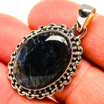Sterling silver pietersite pendant with oval blue cabochon, ornate bezel and bail