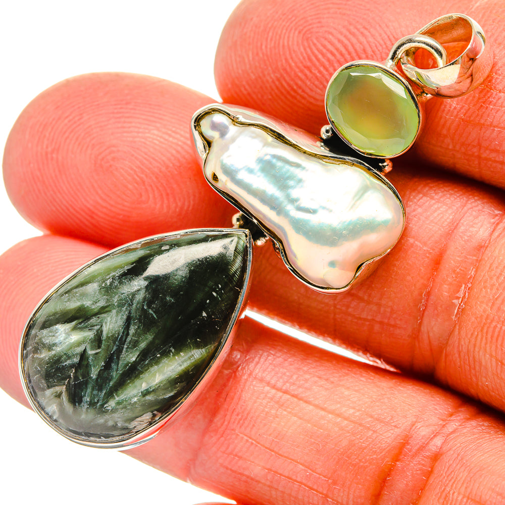 Sterling silver pendant closeup with green and white teardrop cabochons