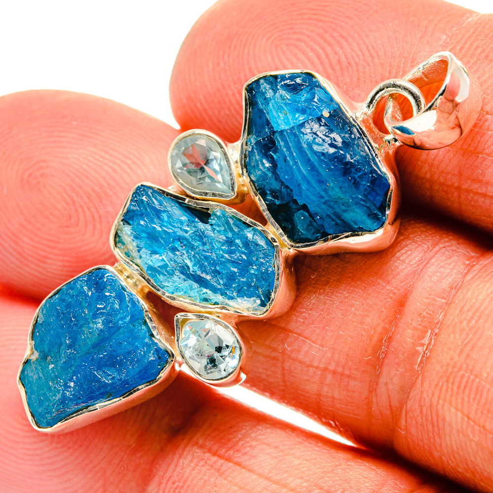 Blue stone pendant with rough topaz pieces and clear round accents in sterling silver.