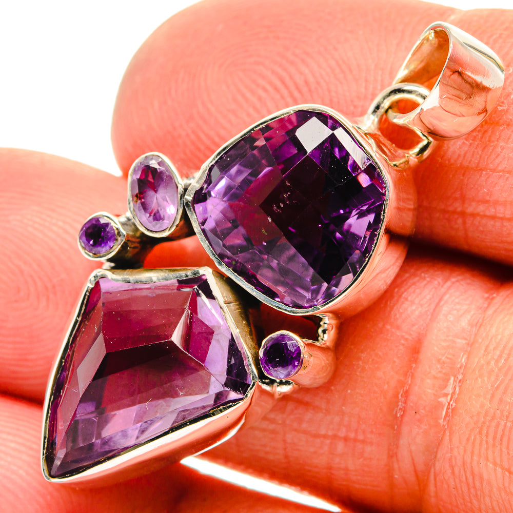 Sterling silver amethyst pendant close-up with oval purple center stone and small round accents