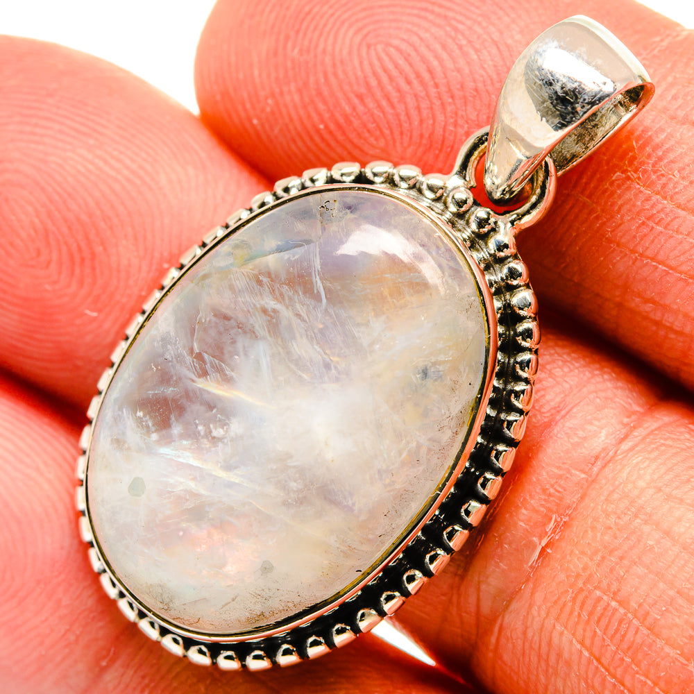 Oval moonstone pendant in 925 sterling silver with bead and dark border, hinged bail.