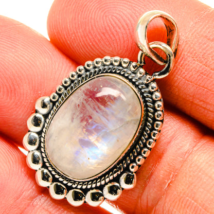 Close-up oval moonstone pendant with rainbow sheen, beaded bezel and round silver frame