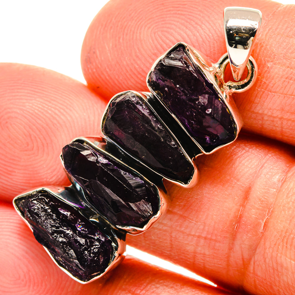 Rough amethyst pendant close-up with dark purple stones in sterling silver bezel