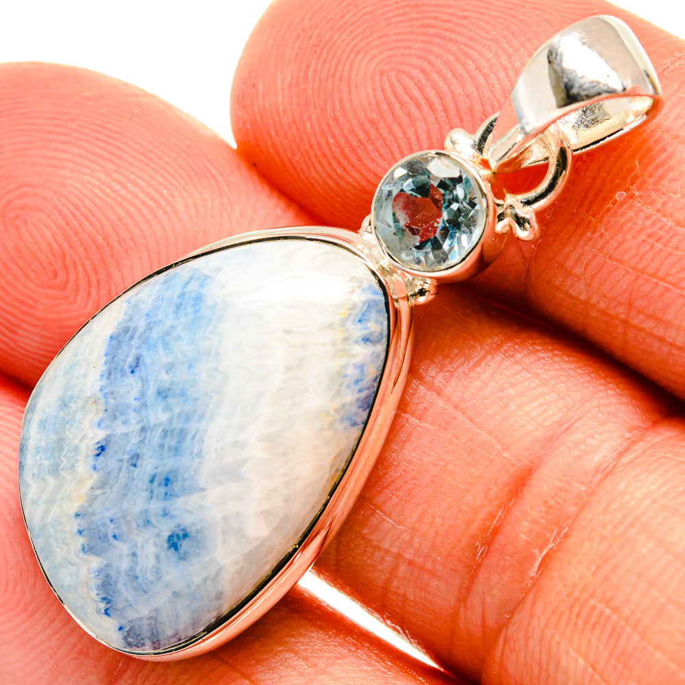Sterling silver pendant with oval blue stone and small round faceted blue gemstone bail