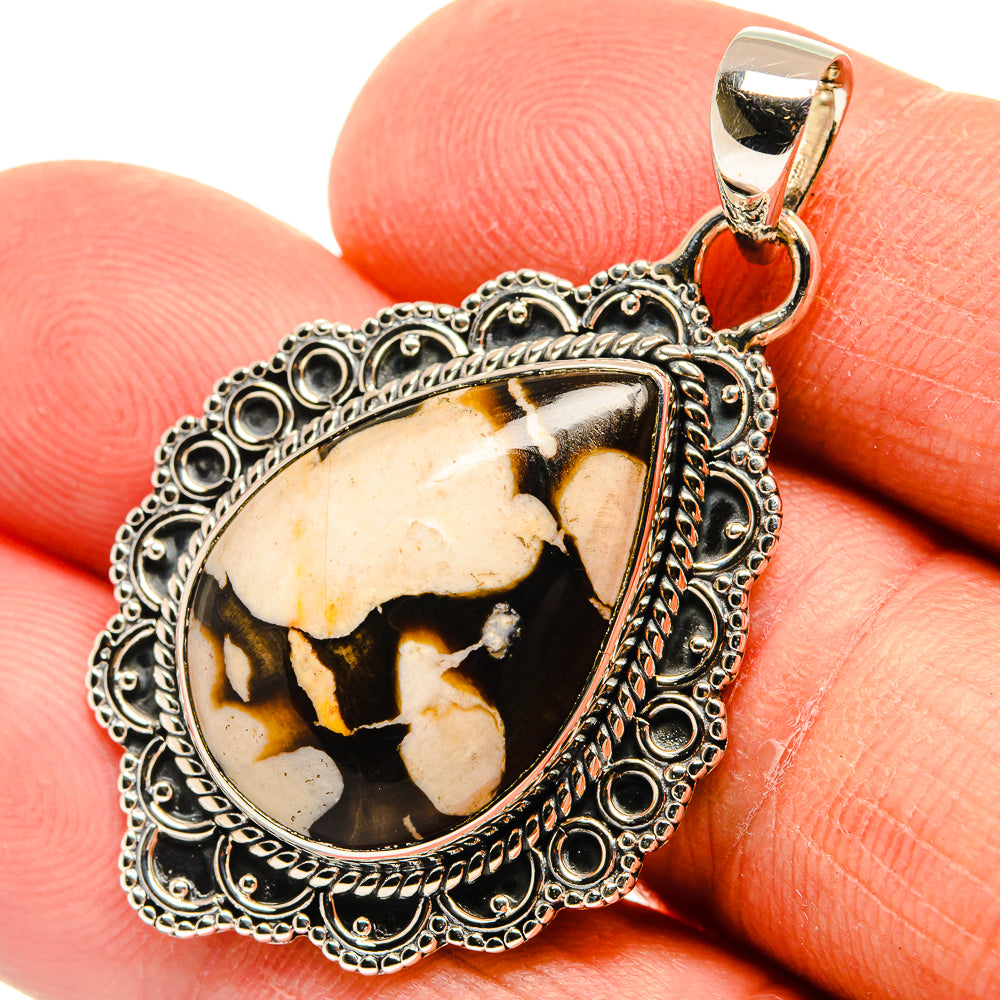Teardrop jasper pendant with ornate silver frame and gold bail, patterned cream and brown stone
