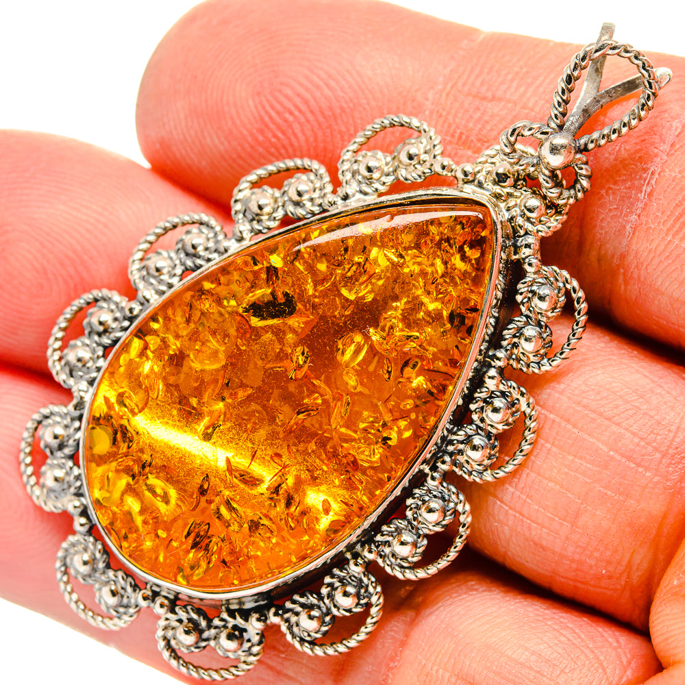 Amber teardrop pendant in ornate 925 sterling silver setting with chain