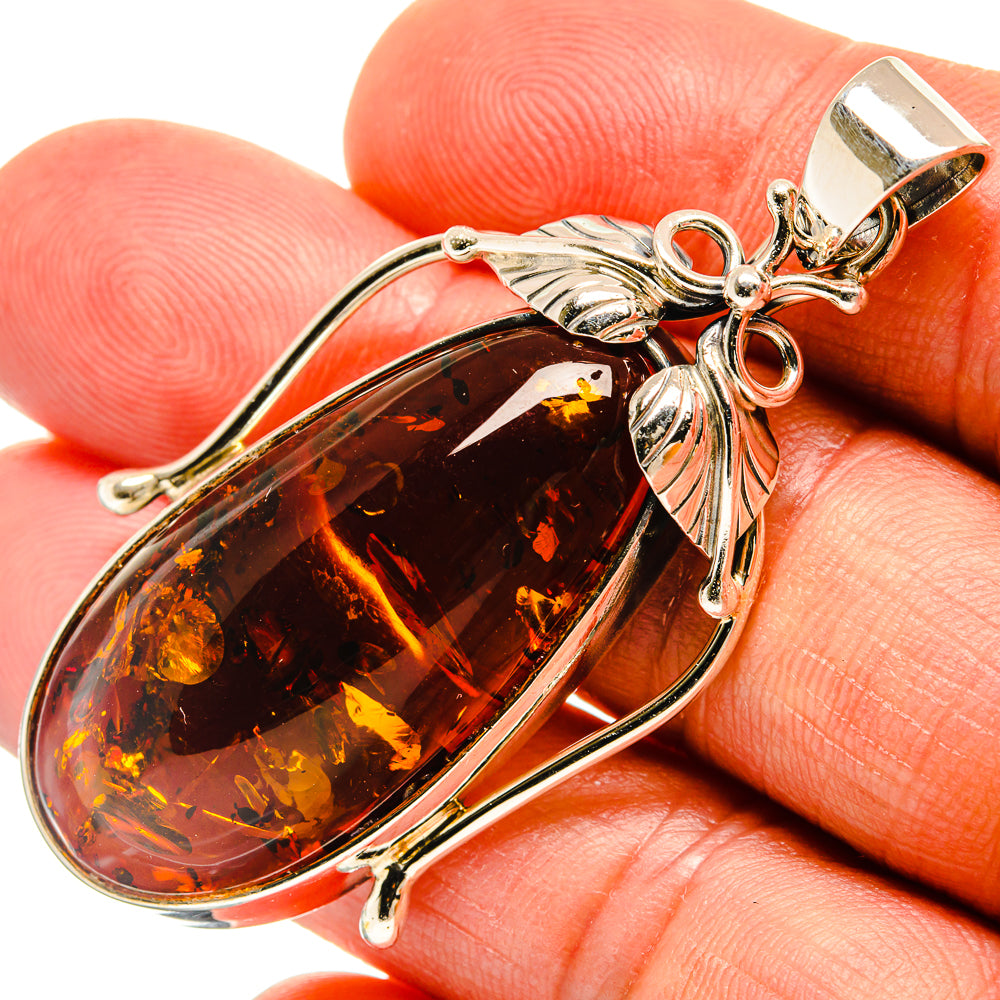 Amber teardrop pendant, 925 sterling silver with leaf-style accents