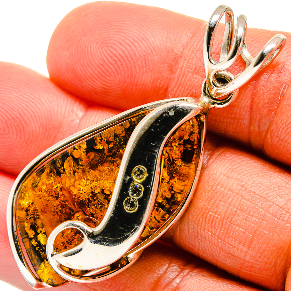 Baltic amber teardrop pendant in 925 sterling silver with black and amber resin inlay