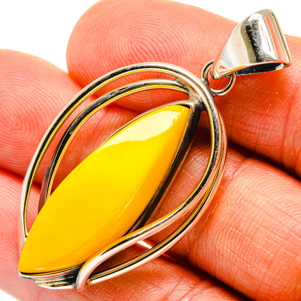 Amber pendant with yellow teardrop stone and polished sterling silver frame